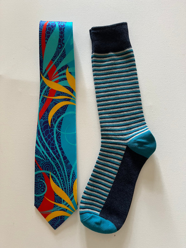 Whimsical in blue silk tie with striped socks