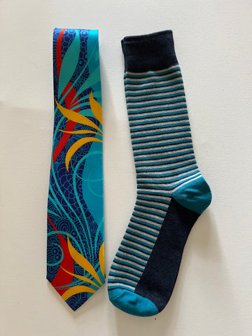 Whimsical in blue silk tie with striped socks